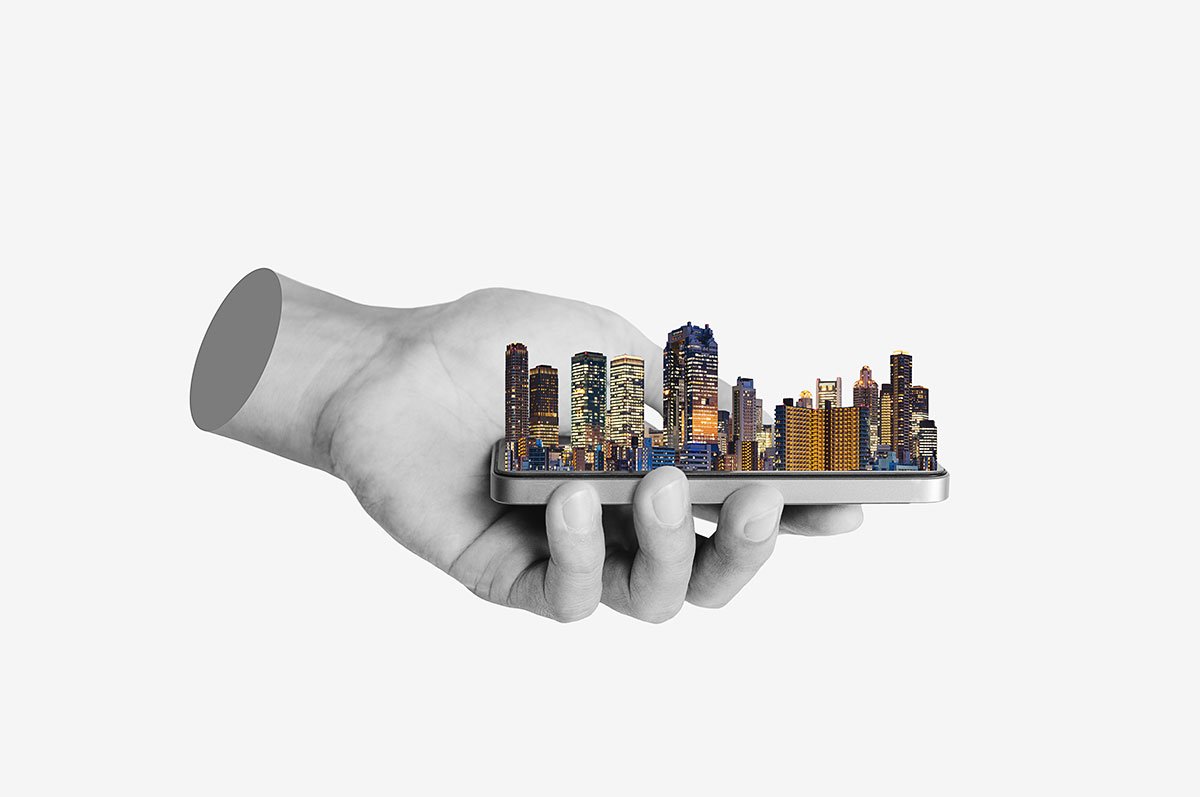 A hand holding a miniature city skyline